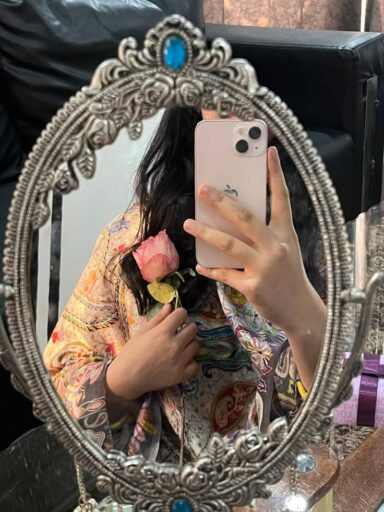 girl in mirror holding iphone and flower in her hand ,girls attitude dp
