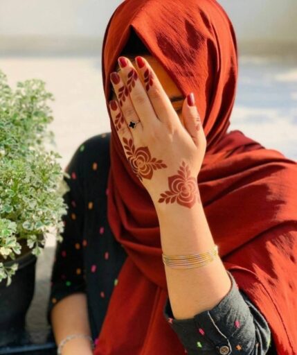 girls style and hiding her face with her mehandi hand